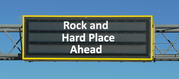 Rock and a hard place sign on a highway